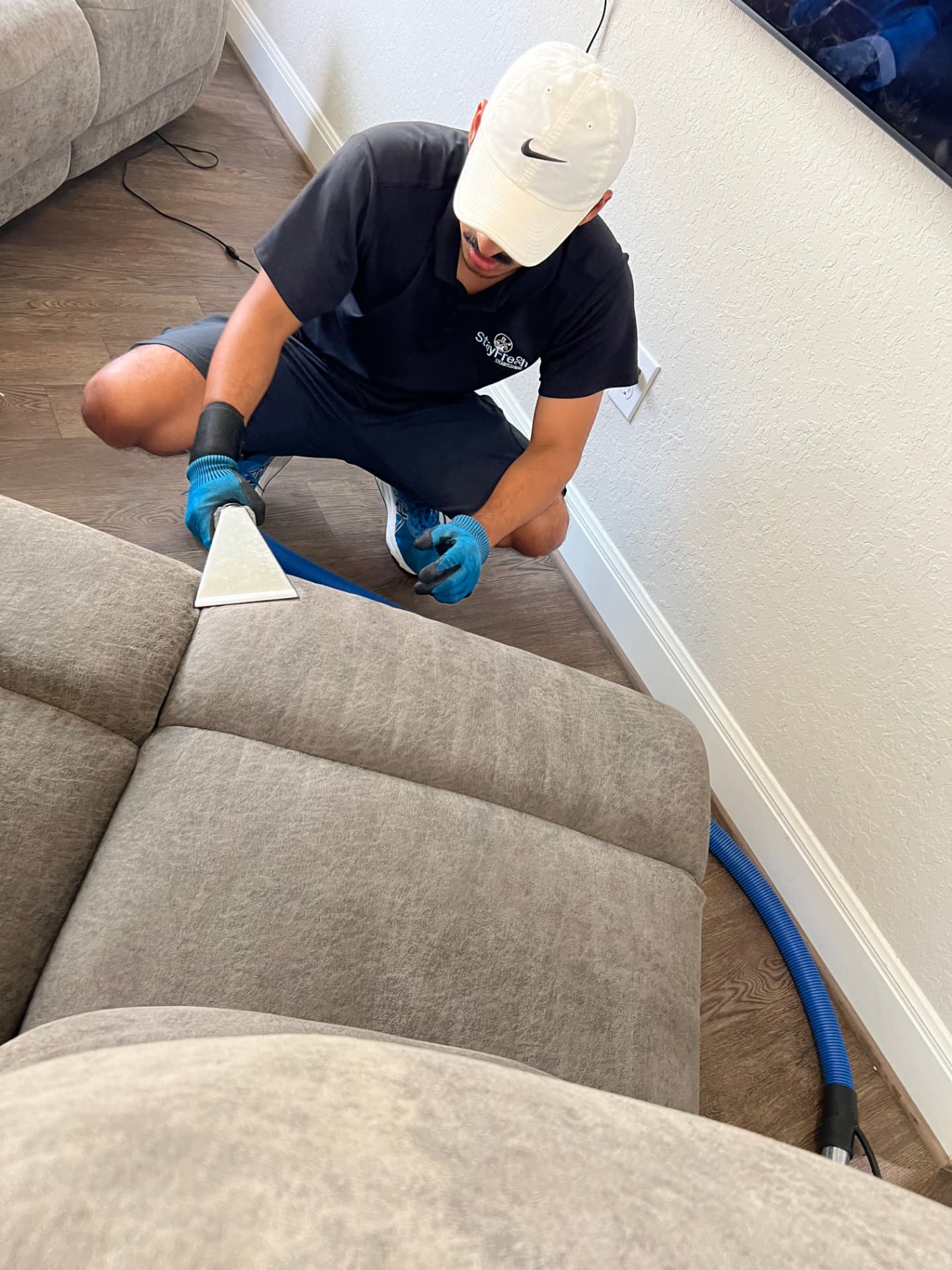 Stay Fresh Steam Cleaning technician deep cleaning a sectional sofa in a San Antonio, TX home